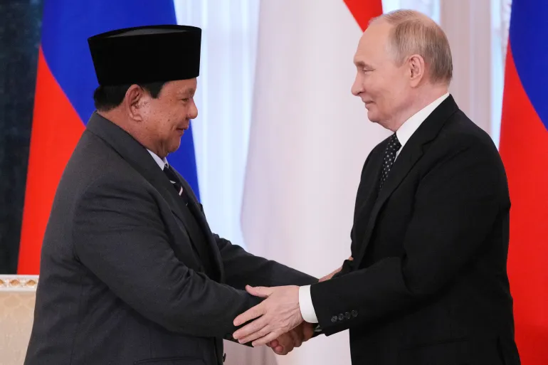 Russian President Vladimir Putin shakes hands with Indonesia's President Prabowo Subianto after their talks on the sidelines of the St Petersburg International Economic Forum in the Konstantin palace, Russia