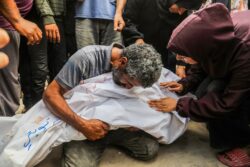 A man hugs the body of a dead loved one at Nasser hospital after an Israeli attack on the al-Mawasi area in Gaza
