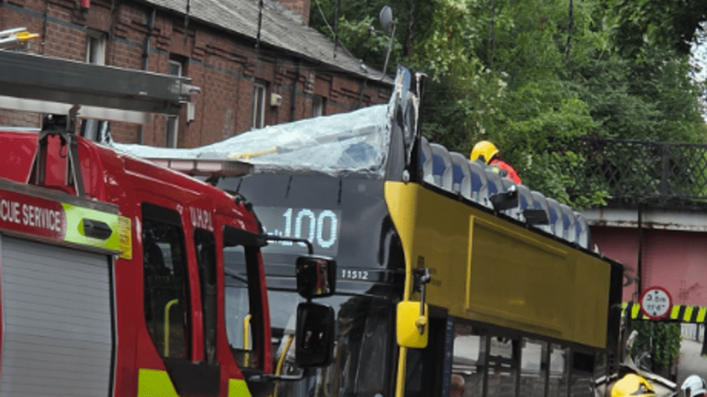 Double decker bus crashes into bridge in Manchester