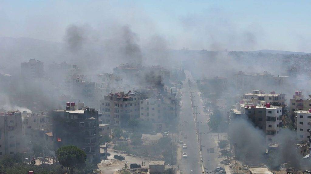 Homes still burning after mass pillaging and 30,000 trapped in besieged city as Syria’s fragile ceasefire holds