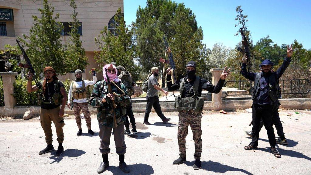 Syrian government forces deploy after clashes in southern city