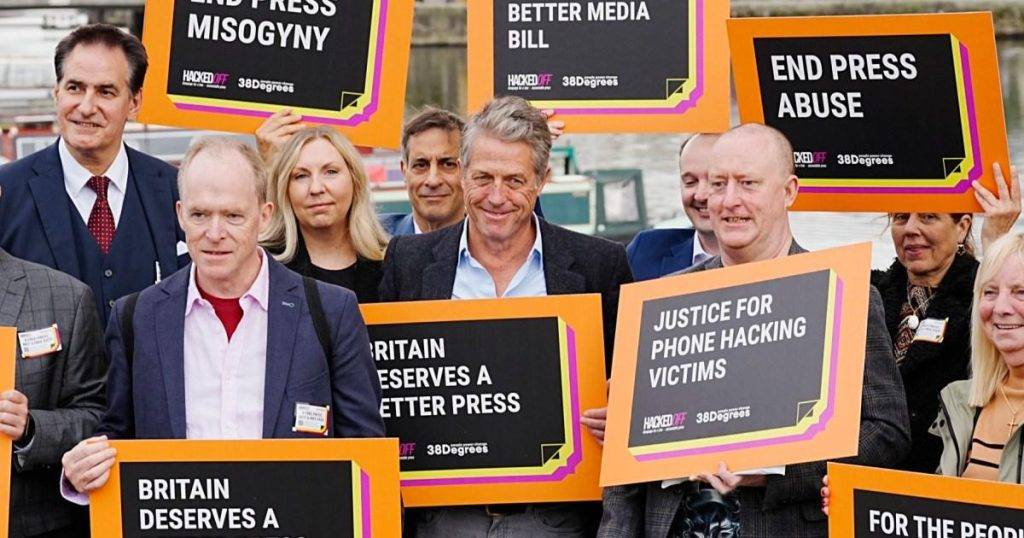 Hugh Grant proudly holds sign with campaigners outside Labour Party conference