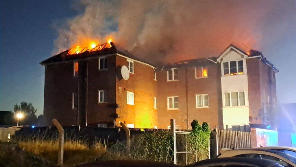 Three children taken to hospital after fire tears through three-storey block of flats in Enfield