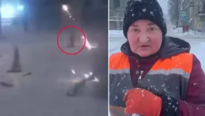 Ukrainian street cleaner pauses briefly during drone strike