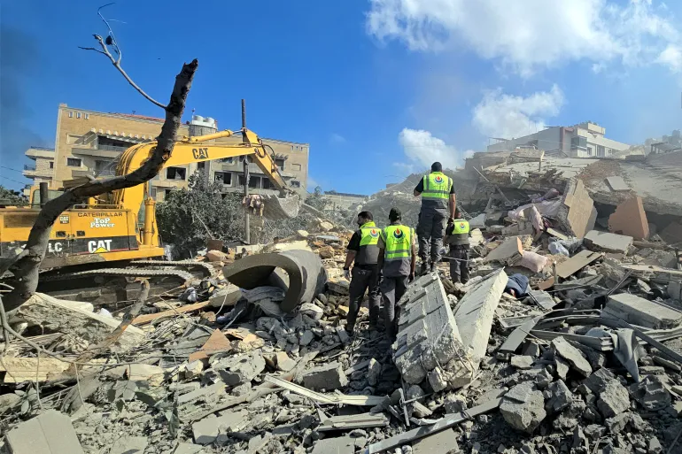Lebanese civil defence workers search through the rubble of a building following an Israeli strike at dawn in the southern Lebanese area of al-Hosh, near the coastal city of Tyre on May 26, 2026.