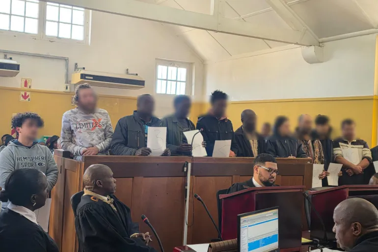 11 suspects appeared in Swartruggens Magistrate’s Court facing charges including drug manufacturing, illegal possession of hazardous materials, and violations of the Immigration Act.[Handout/SA Police Service]
