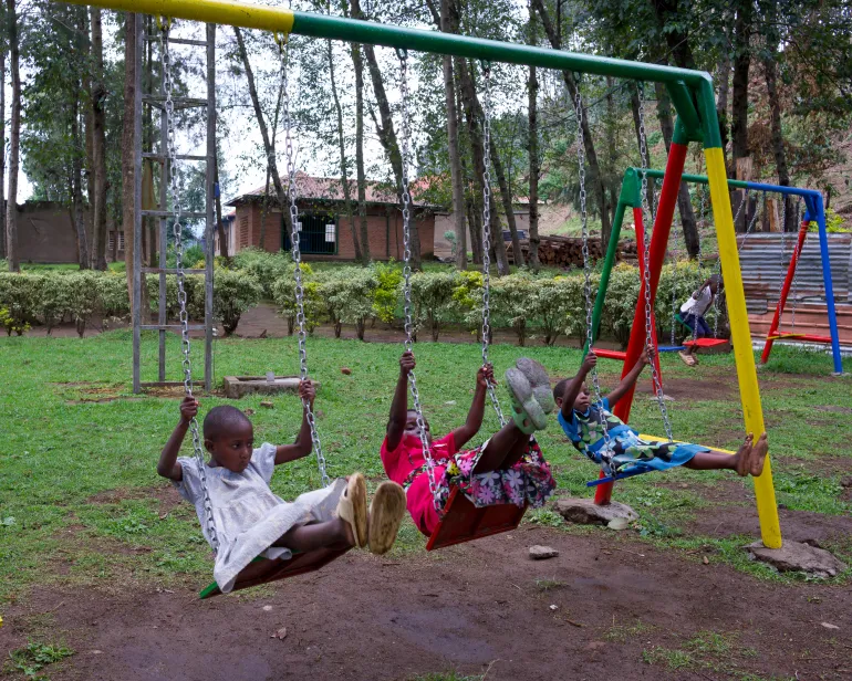 Children play on playground equipment at the Mutobo Demobilisation and Reintegration Centre in northern Rwanda.