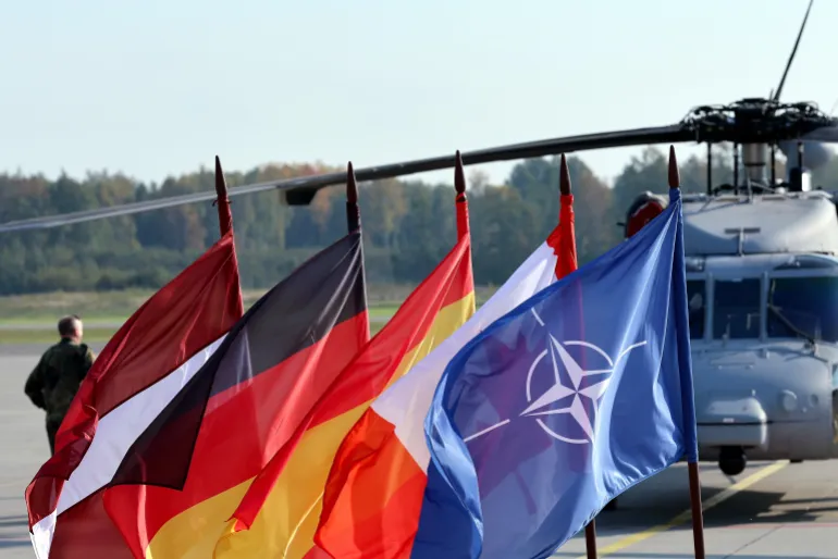 epa13274753 (L-R) Latvian, German, Spain, Canadian and NATO flags are seen during a NATO Media Day at Lielvarde Air Base, Latvia, 01 October 2026. The press tour across Lithuania and Latvia provided international media with access to live and static operational activity, high-level briefings and visual opportunities, NASAMS (Ground based Air Defence System) and C-UAS systems. EPA/TOMS KALNINS